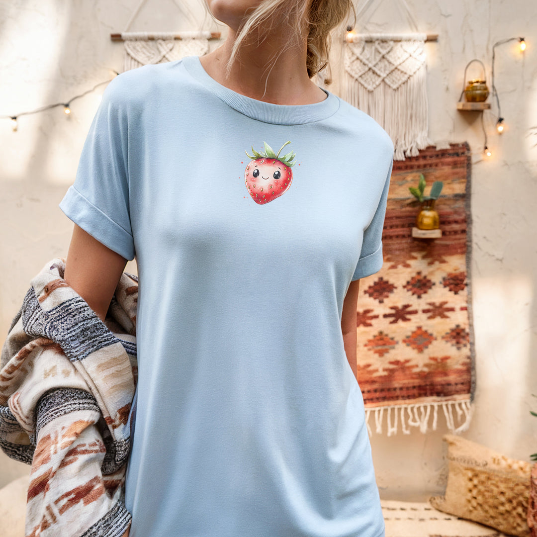 a woman wearing a blue shirt with a strawberry on it