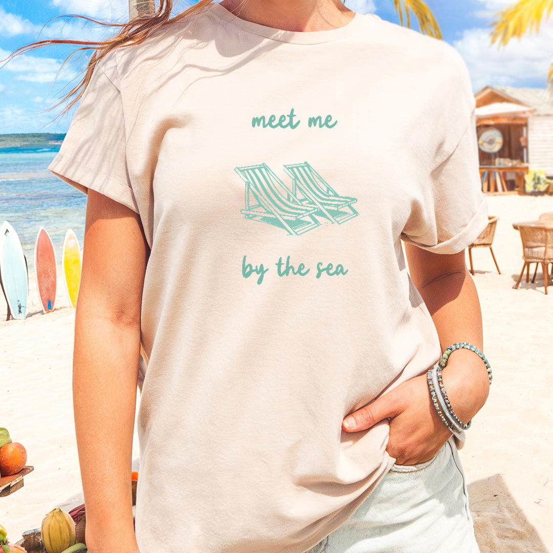 a woman standing on a beach next to the ocean