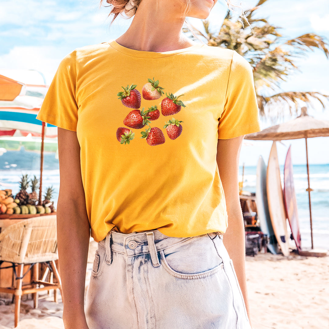 a woman wearing a strawberries t - shirt on the beach