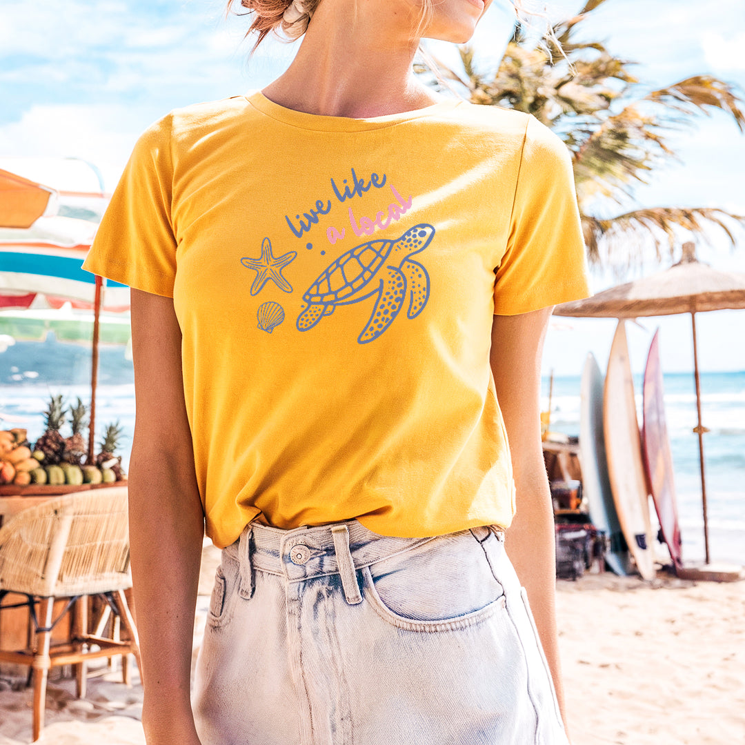 a woman in a yellow shirt is standing on the beach