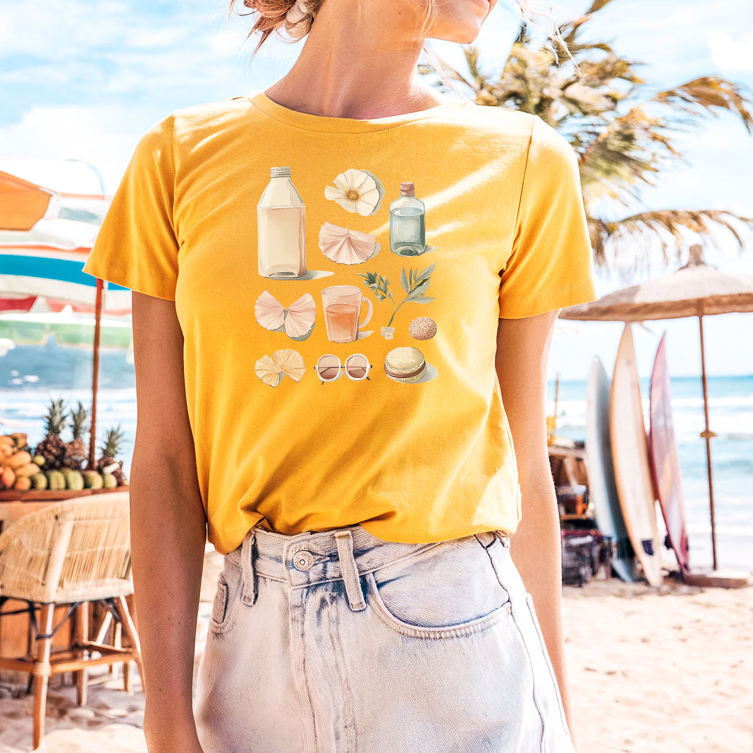 a woman standing on a beach wearing a yellow shirt