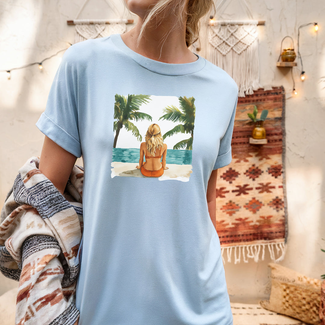 a woman wearing a t - shirt with a picture of a woman sitting on a