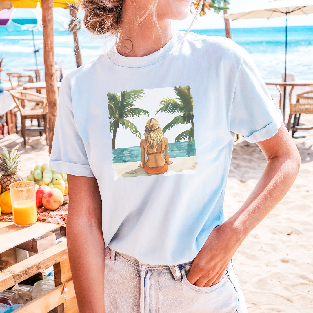 a woman wearing a t - shirt with a picture of a woman sitting on a