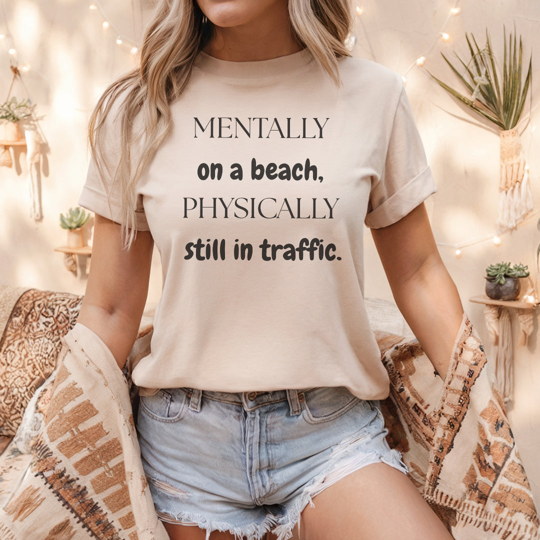 a woman wearing a t - shirt that says mentally on a beach, physically still