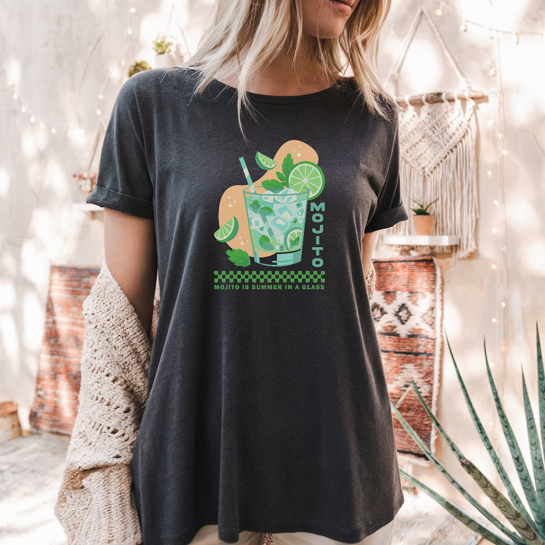 a woman standing in front of a cactus wearing a t - shirt