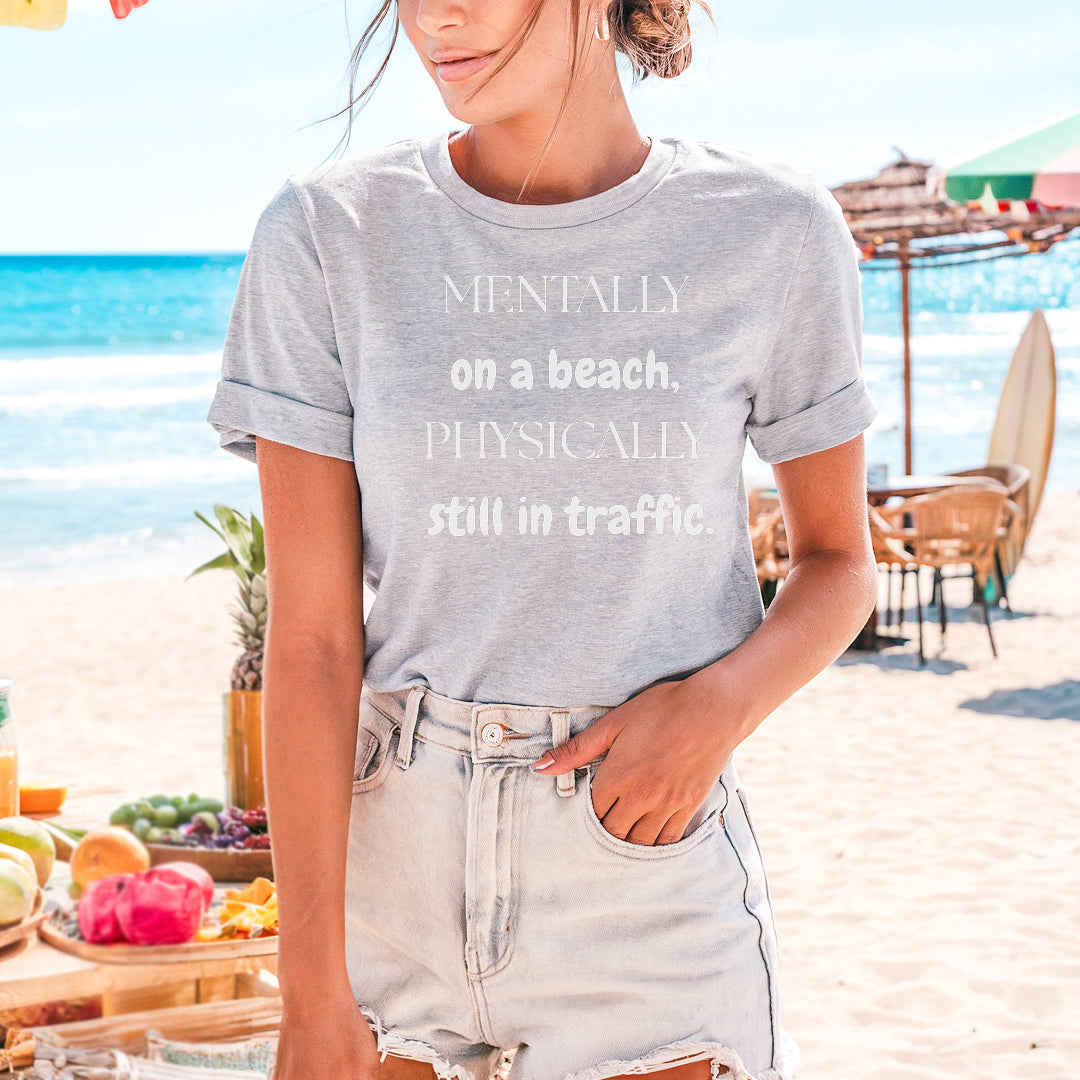 a woman standing on a beach next to the ocean