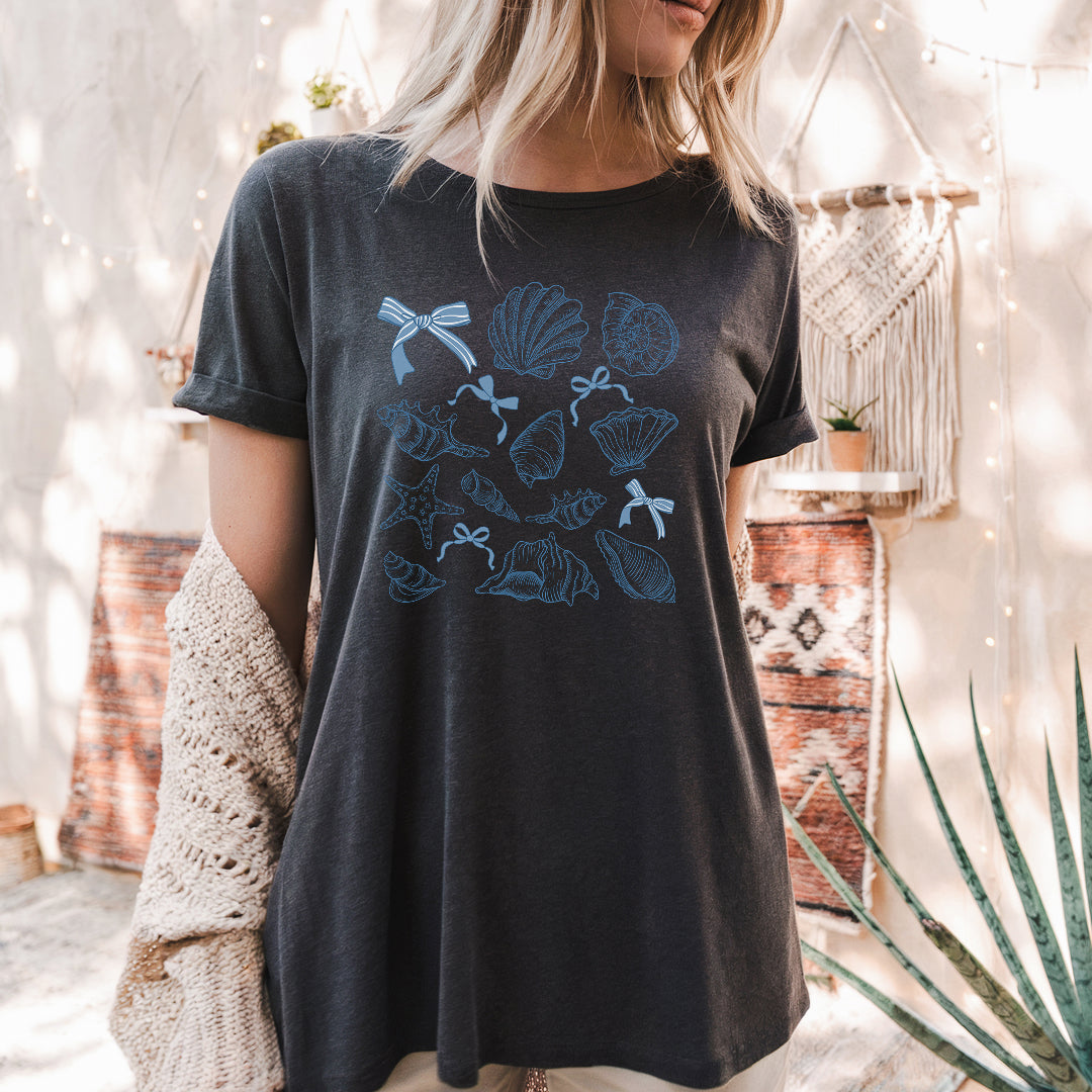 a woman wearing a black t - shirt with blue flowers on it