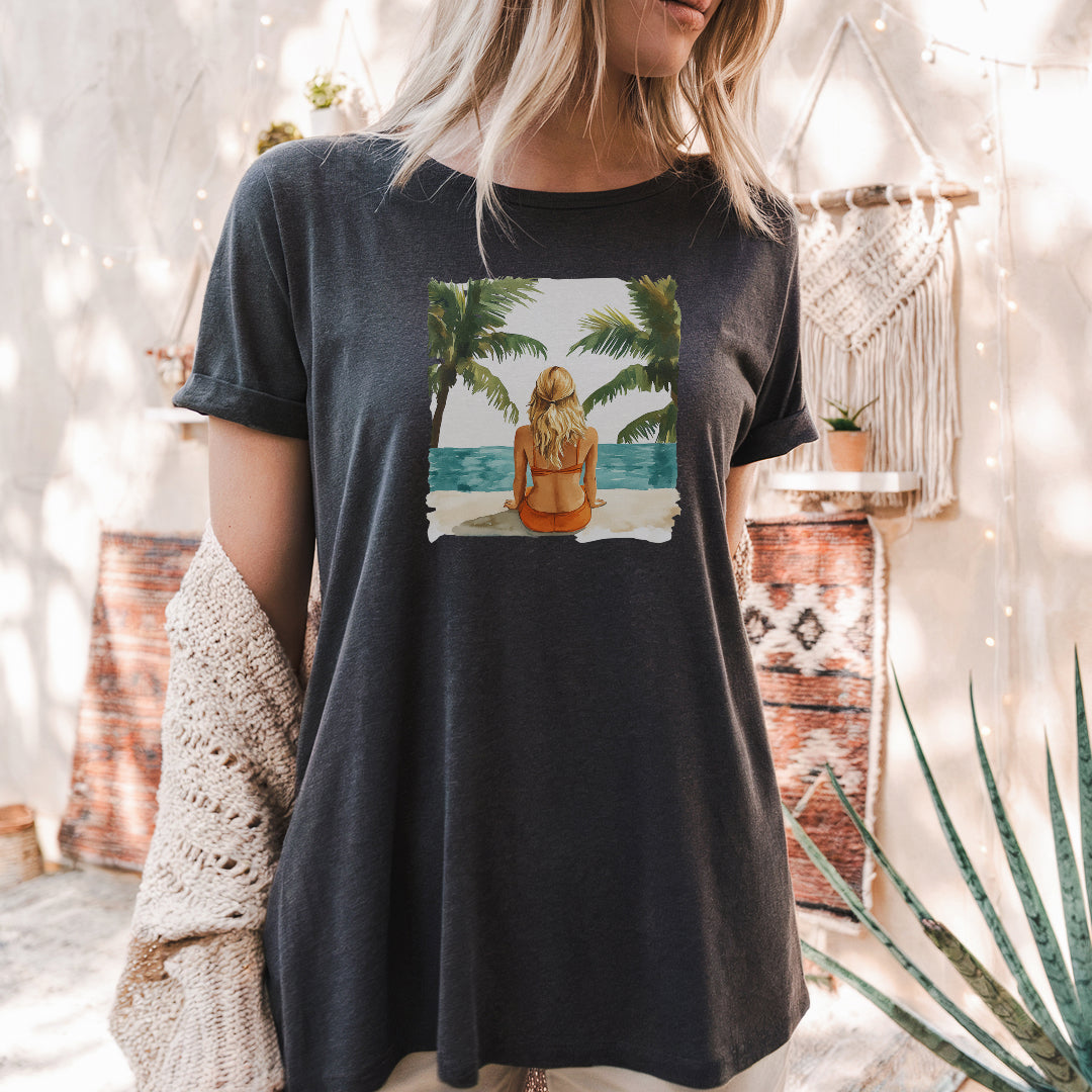 a woman wearing a t - shirt with a picture of a woman sitting on a