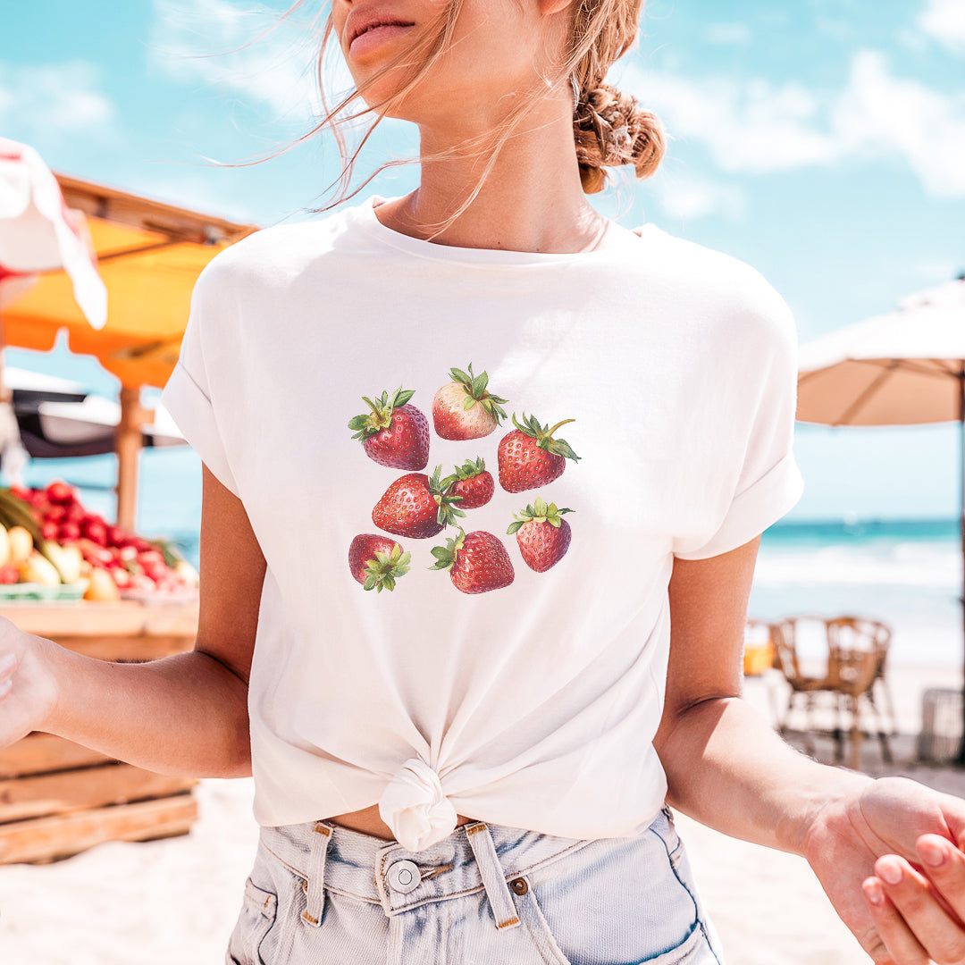a woman wearing a strawberries t - shirt on the beach