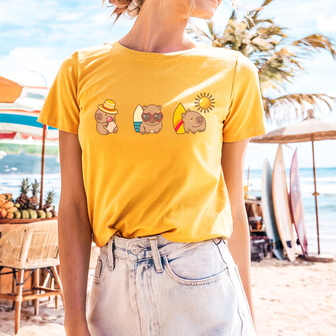 a woman standing on a beach wearing a yellow shirt