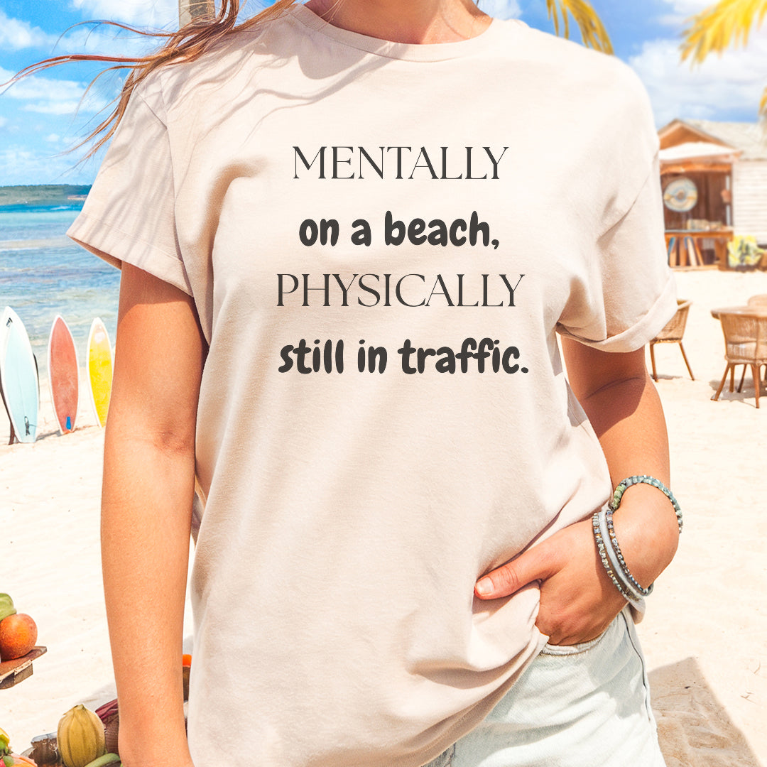 a woman wearing a t - shirt that says mentally on a beach, physically still