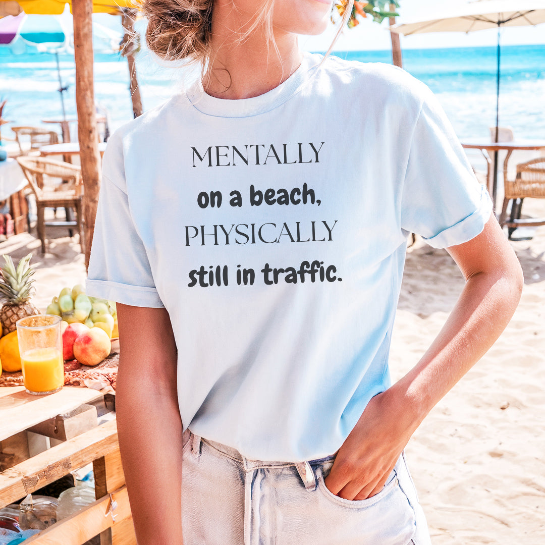 a woman wearing a t - shirt that says mentally on a beach, physically still