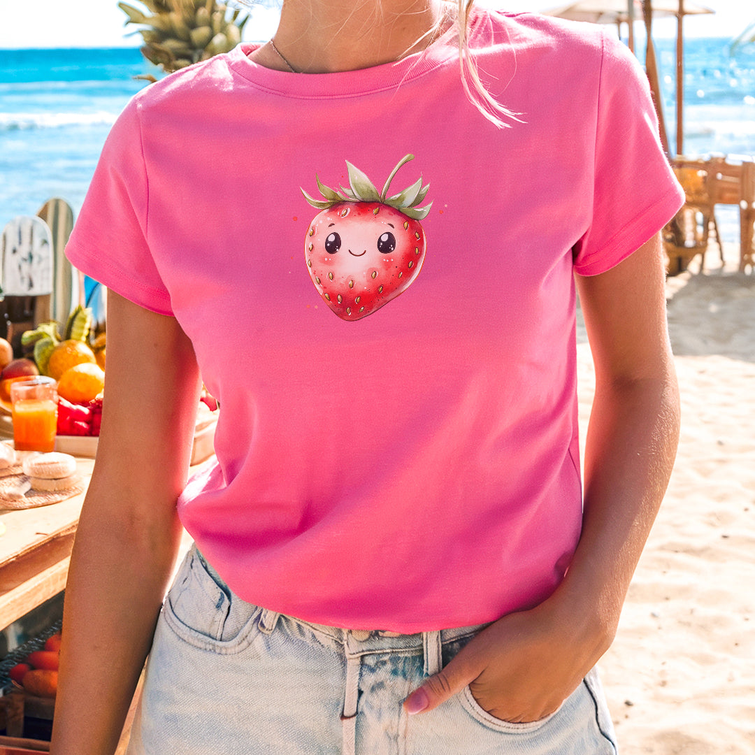 a woman wearing a pink shirt with a strawberry on it