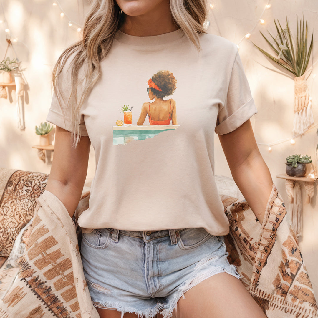 a woman sitting on a bed wearing a t - shirt with a picture of a