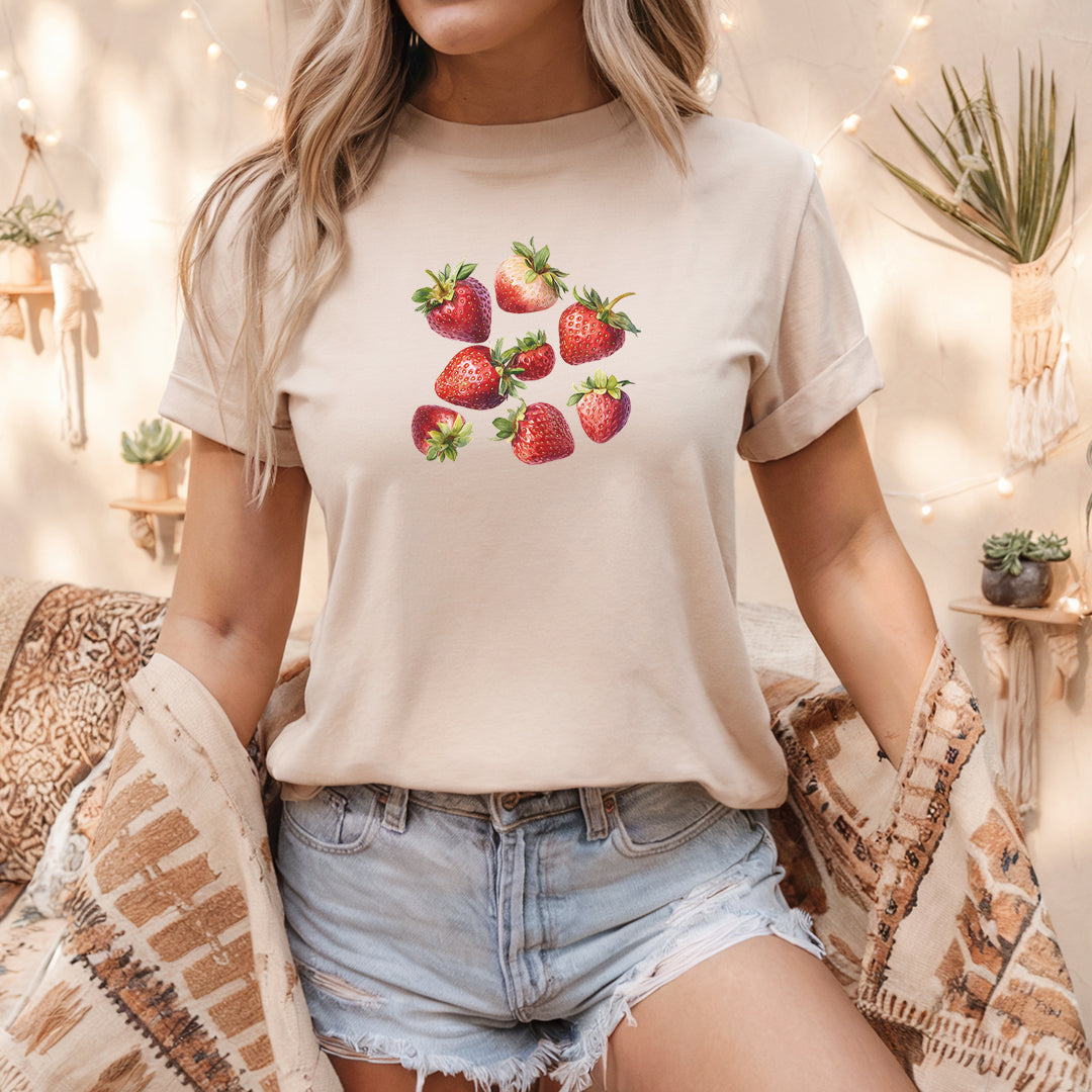 a woman wearing a t - shirt with strawberries on it