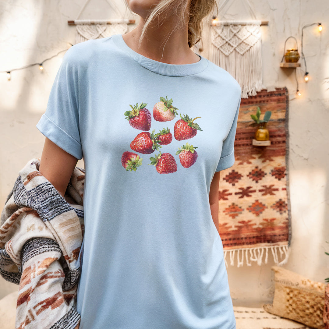 a woman wearing a blue shirt with strawberries on it
