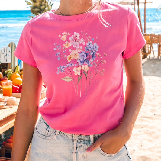 a woman wearing a pink shirt with flowers on it