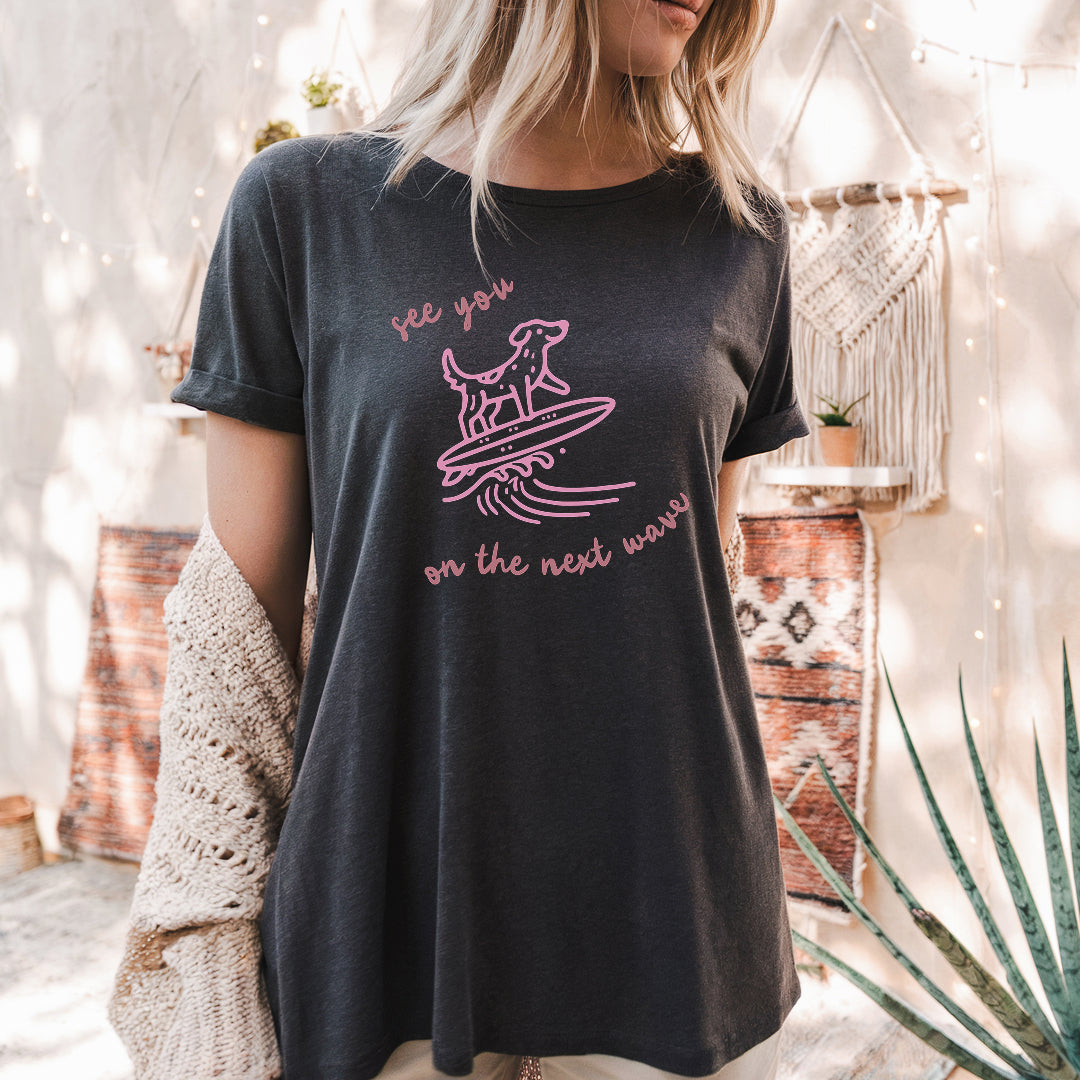 a woman wearing a black shirt with pink writing on it