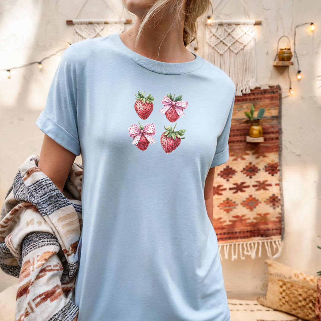 a woman wearing a blue shirt with strawberries on it