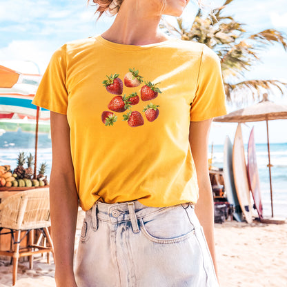 a woman wearing a strawberries t - shirt on the beach