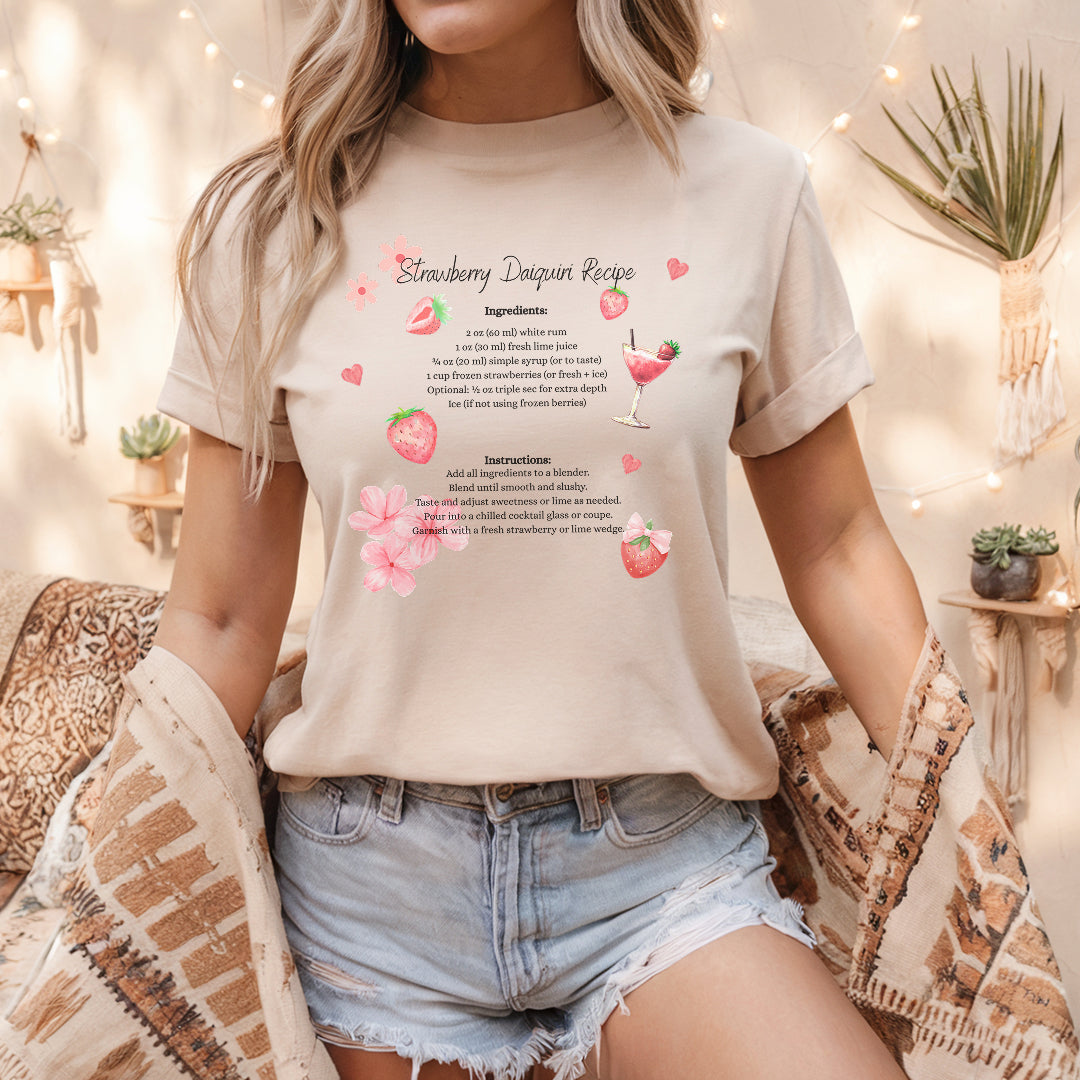 a woman sitting on a bed wearing a t - shirt