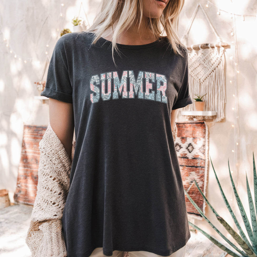 a woman wearing a black shirt with the word summer printed on it