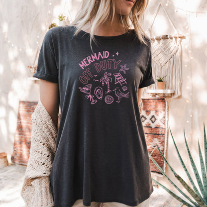 a woman wearing a black shirt that says mermaid on it