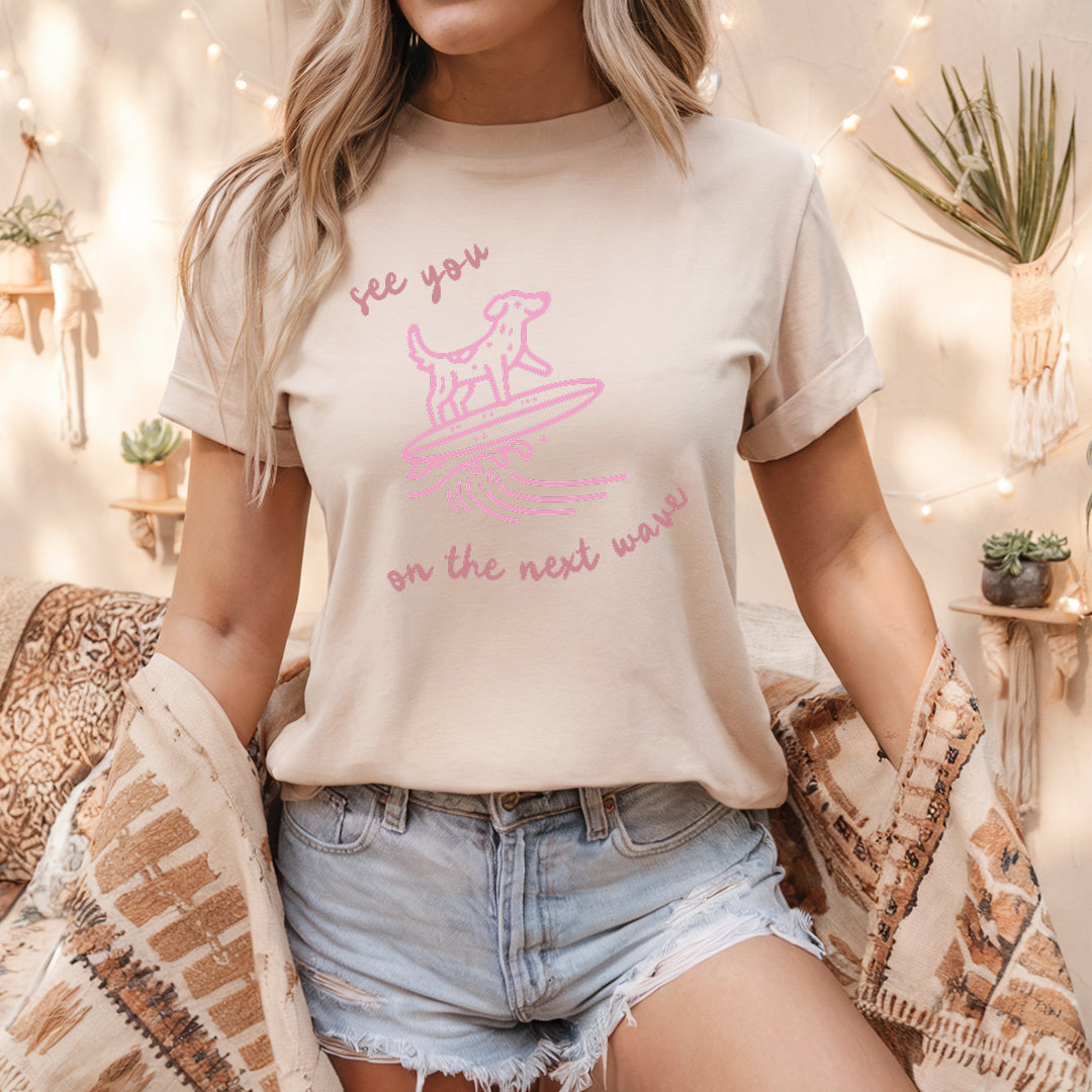 a woman sitting on a bed wearing a t - shirt with a dog on it