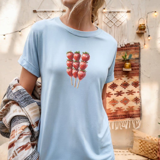 a woman wearing a blue shirt with strawberries on it
