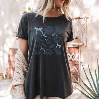 a woman wearing a black t - shirt with blue flowers on it