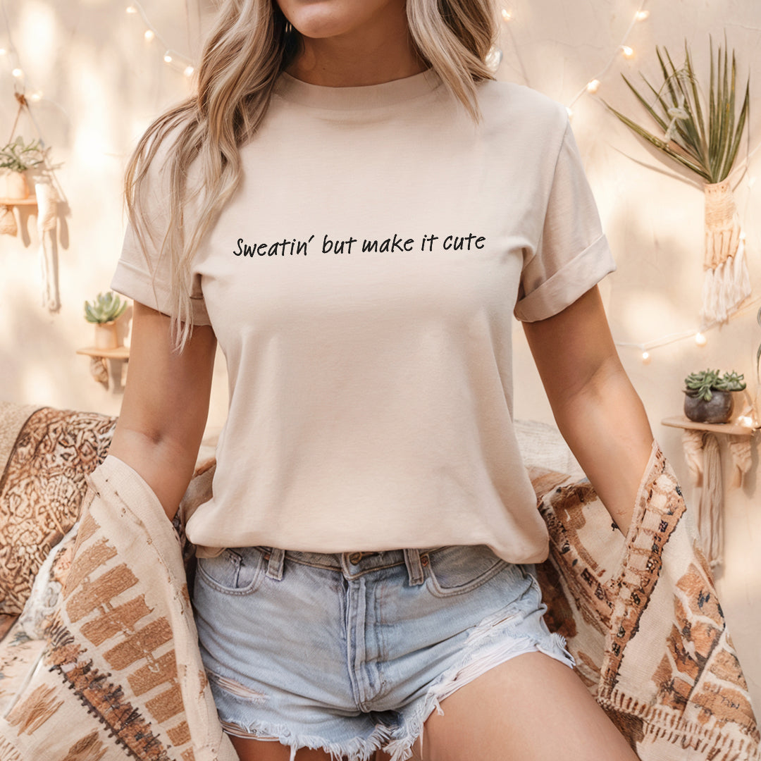 a woman sitting on a bed wearing a t - shirt