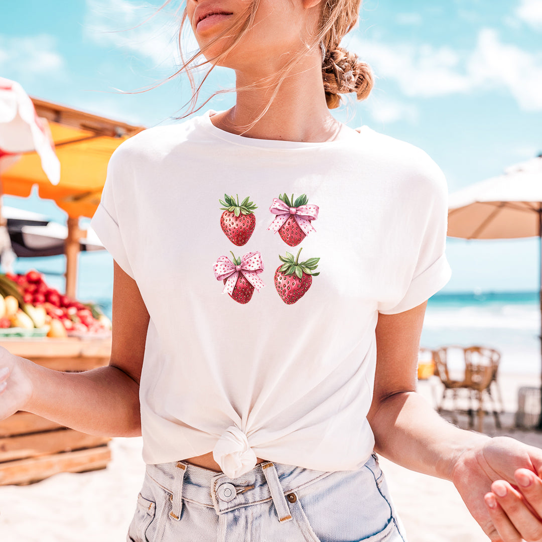 a woman wearing a white shirt with strawberries on it