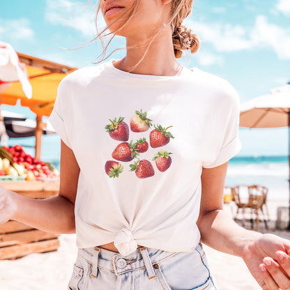 a woman wearing a strawberries t - shirt on the beach