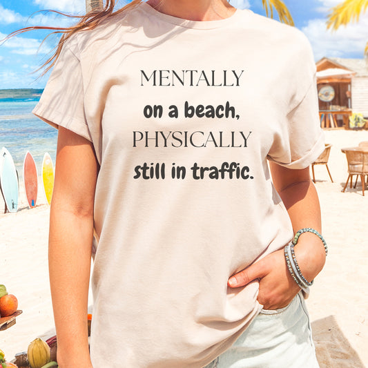 a woman wearing a t - shirt that says mentally on a beach, physically still