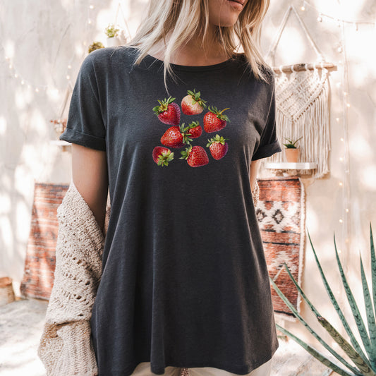 a woman wearing a black shirt with strawberries on it