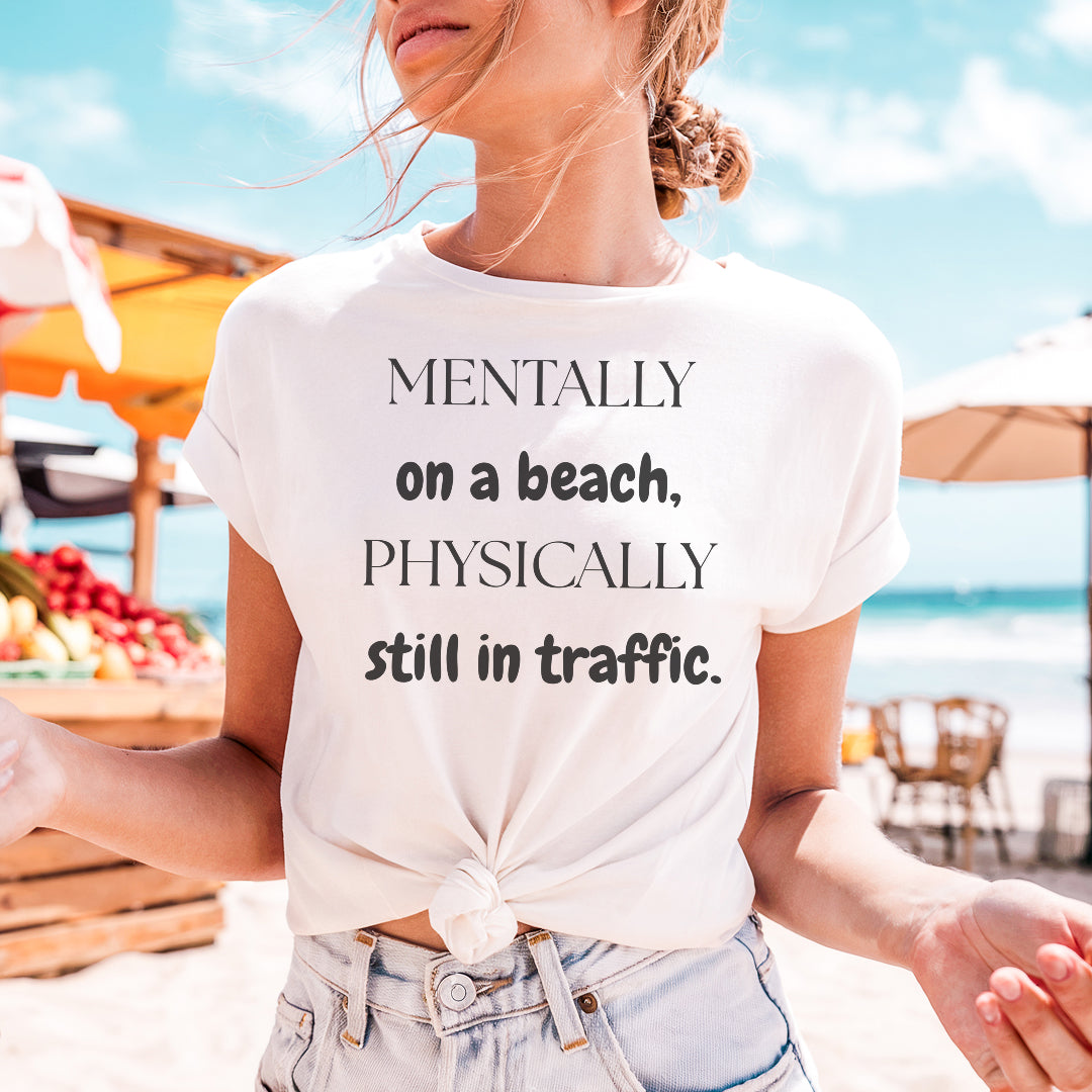 a woman standing on a beach wearing a t - shirt that says mentally on a