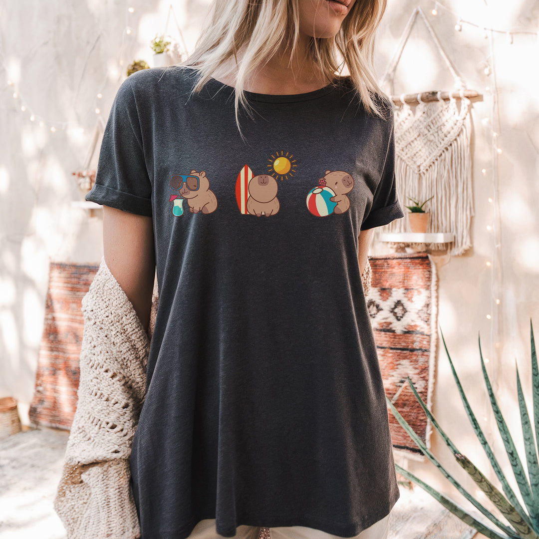 a woman standing in front of a cactus wearing a t - shirt