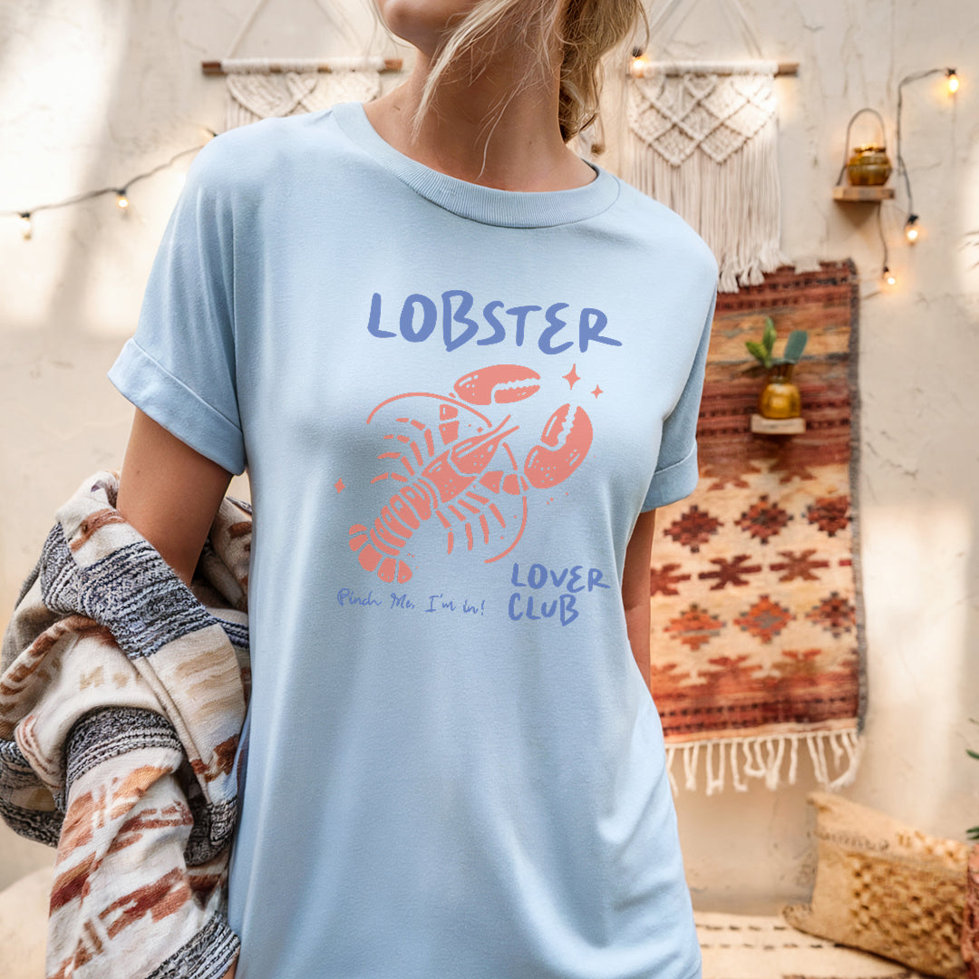 a woman wearing a lobster t - shirt standing in a room