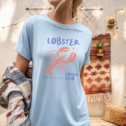 a woman wearing a lobster t - shirt standing in a room