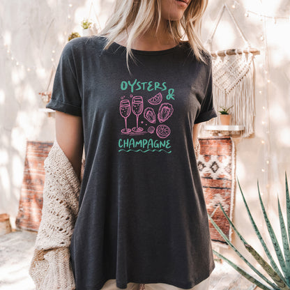 a woman wearing a black shirt that says oysters and champagne
